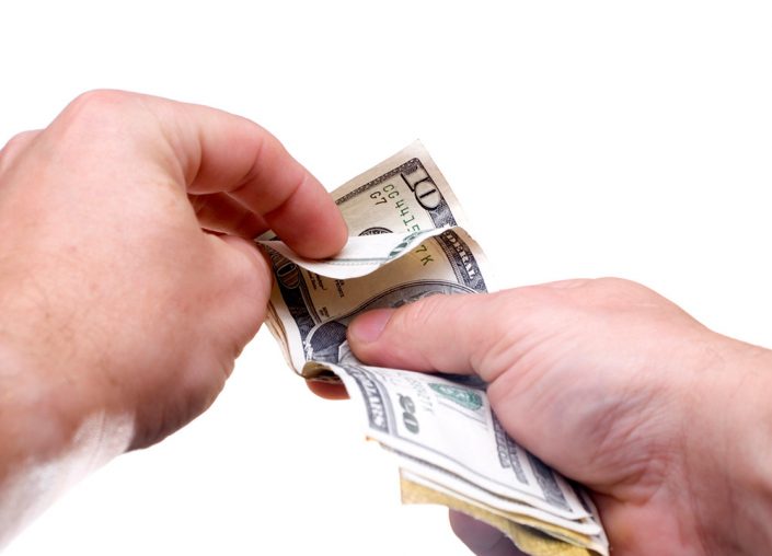 Look Closely at Your ROI In Print Ads man counting money image georgia web development